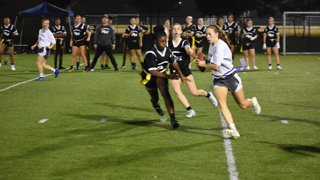 Calvary Day quarterback Hannah Cail runs around left end during a flag football game against host Richmond Hill during a doubleheader on last season at Henderson Park. CDS won the first game 16-0, and the Wildcats claimed the second game 7-6.