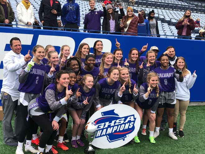 The Calvary Day School girls flag football team poses for a photo after defeating Portal 6-0 in the first-ever GHSA Class 1A-5A state championship game on Dec. 28, 2020 at Center Parc Stadium in Atlanta.