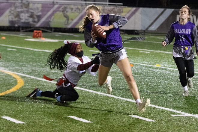 Calvary Day's Hannah Cail runs around the left end in a flag football playoff win earlier this school year.