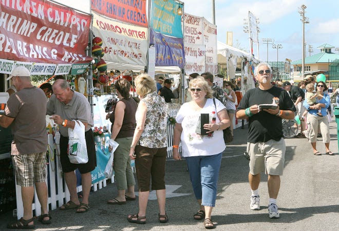 People sample food at the Destin Seafood Festival in 2007 at the Morgan Sports Center.