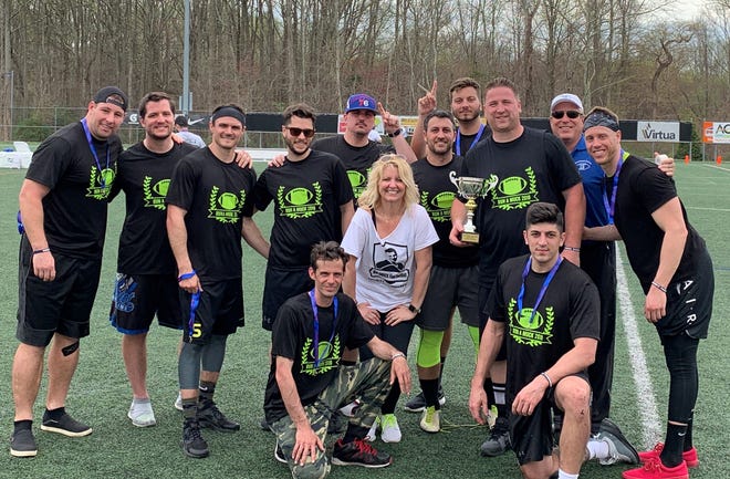 Winners in the Run Amuck Flag Football tournament in April of 2019. The annual fundraising tournament was created in memory of former Washington Township High School football player Austin Muckenfuss, who died in 2015. Austin's mother Kim Muckenfuss (center) and father Rich (right, blue shirt and white hat) are pictured.