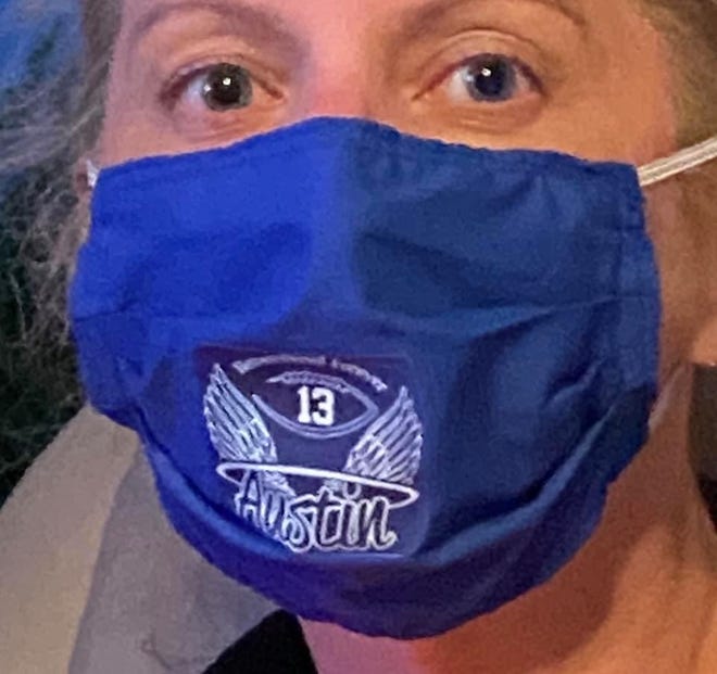 Kim Muckenfuss of Washington Township is shown wearing a facemask being made in her late son's honor. The masks are being sold for $10 and are going towards fundraising efforts for the Austin Muckenfuss Scholarship Fund, which has given out more than $33,000 in scholarships to graduating seniors since her son died in 2015.