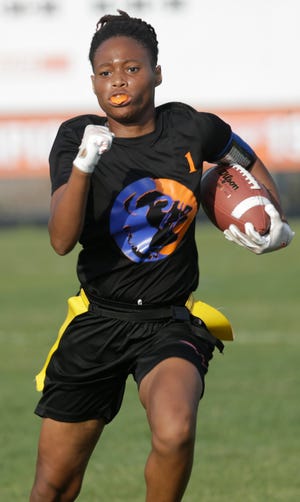 Kymani Freeman of Southeast High breaks away for a big gain against Seminole Osceola on Friday night in Bradenton.