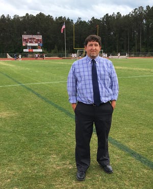 South Effingham's new athletic director Nick Smith surveys the field before a soccer game April 15.