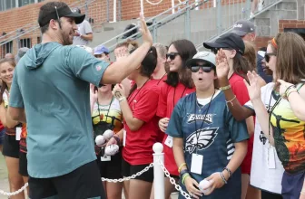 Players with the Athena Athletics Girls Flag Football program react as Eagles head coach Nick Sirianni greets them at the end of a joint training camp with the New England Patriots at the NovaCare Complex in South Philadelphia on Tuesday, Aug. 17, 2021.