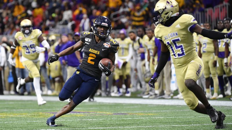 North Carolina A&T wide receiver Korey Banks (2) cuts back on Alcorn State defensive back Keyron Kinsler Jr. (15) during a long run in the second half of the Celebration Bowl Saturday, Dec. 21, 2019, at Mercedes-Benz Stadium in Atlanta.