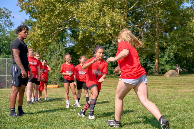 Area girls go through football drills during Felicia Mycyk's all-girls football camp in September 2021 in Ambridge.