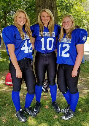 Mooresville's Elise Scaggs (middle) with her two sisters. The trio plays with the Indiana Girls Tackle Football League.