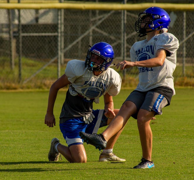 Menendez kicker Bryce Addison (right) watches a field goal attempt during practice. The senior committed to Mercer football.