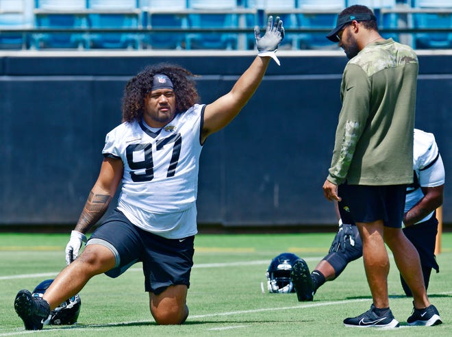 Jacksonville Jaguars defensive tackle Jay Tufele (97) talks with associate strength coach Kevin Maxen during the Jaguars rookie minicamp session at TIAA Bank Field in Jacksonville, FL Tuesday, June 14, 2022.
