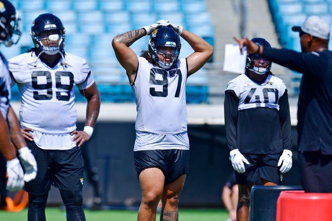 Jacksonville Jaguars defensive tackle Jay Tufele (97) listens to instructions as he goes through drills with his fellow defensive linemen during the Jaguars rookie minicamp session at TIAA Bank Field in Jacksonville, FL Wednesday, June 15, 2022.
