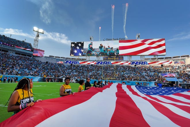 Girls flag football athletes brought the American Flags on the field during the National Anthem for pregame activities before kickoff. The Jacksonville Jaguars hosted the Pittsburgh Steelers in pre-season football at TIAA Bank Field in Jacksonville, FL Saturday, August 20, 2022. The Steelers led at the half 7-6. [Bob Self/Florida Times-Union]