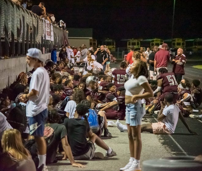 Students, staff, and family members take shelter along with West Creek's football team after shots were fired outside West Creek's football stadium during a game against Northeast Friday, Aug. 19, 2022 in Clarksville.