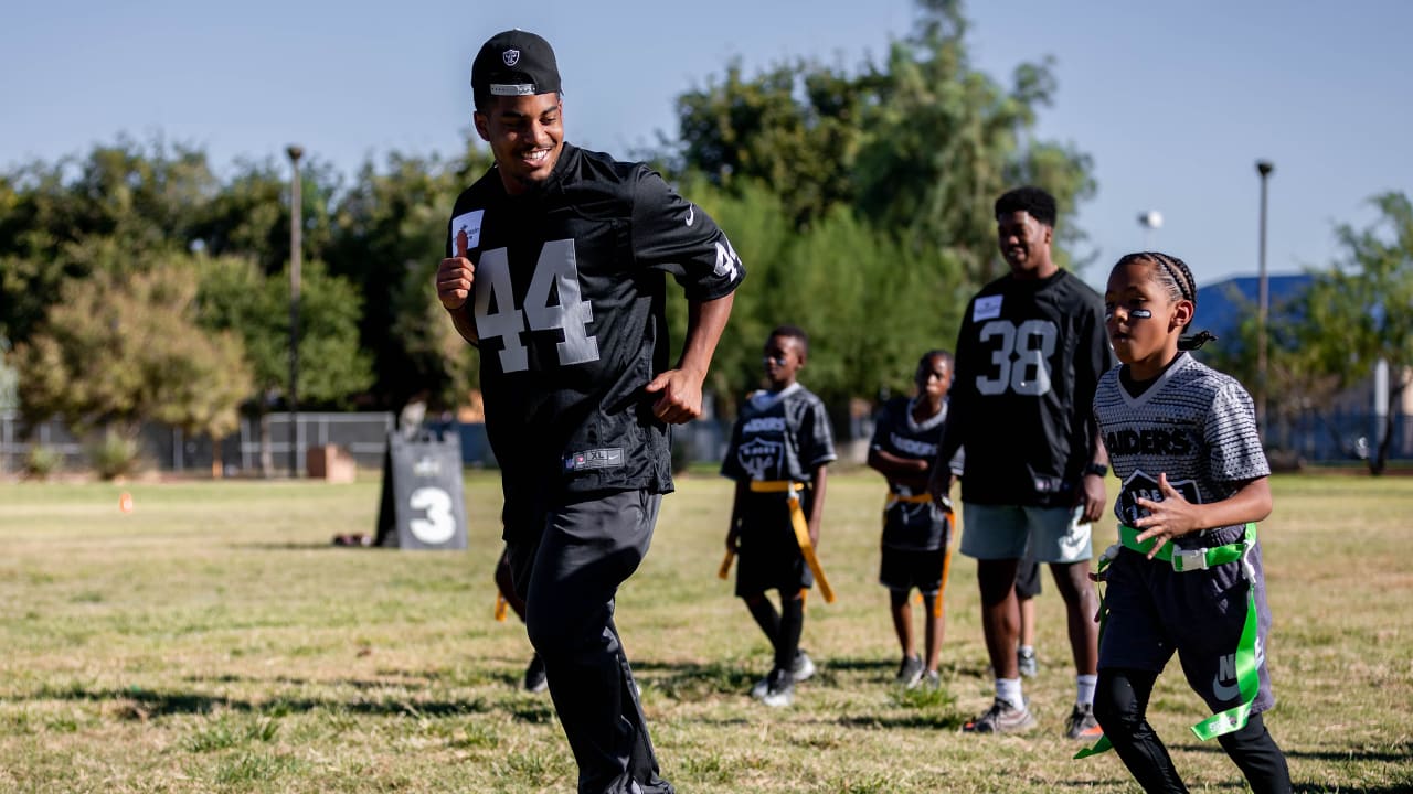 Las Vegas Raiders players lead elementary school students at football camp in advance of Silver & Black Flag League kickoff