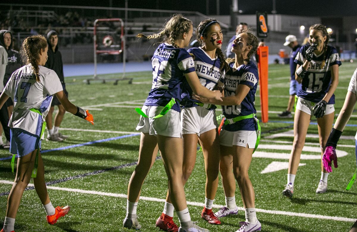 Newport Harbor's Audrey Burns, left, and Isa Whittaker, right, celebrate after Maia Helmar scores a touchdown against CdM.