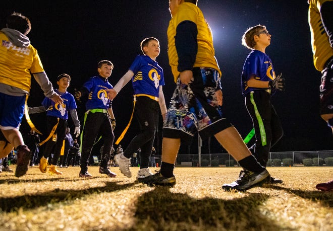 Amelia Earhart Elementary players go down the handshake line with Roosevelt players after their championship win during the DSUSD Elementary Flag Football League Championships at Colonel Mitchell Paige Middle School in La Quinta, Calif., Friday, Dec. 9, 2022. 