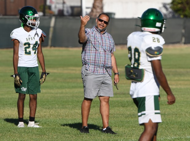St. Patrick-St. Vincent's head coach Lane Hawkins talks players through a coverage route during football practice in Vallejo. (Chris Riley/Times-Herald file)