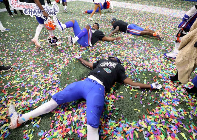 Florida Gators players celebrate after their win against the Michigan Wolverines in the 2018 Peach Bowl at Mercedes-Benz Stadium.