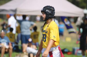 GAME CHANGER—Past Conejo Youth Flag Football Association player Gigi Ciccone stands ready on the field. Courtesy of CYFFA