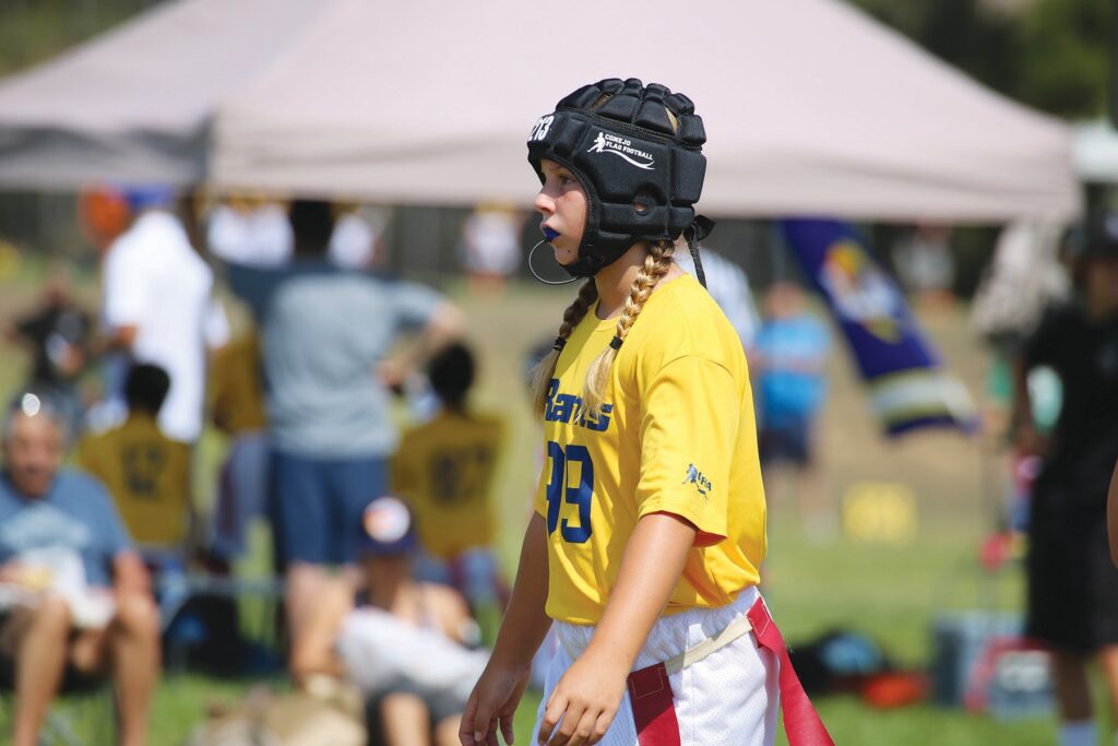GAME CHANGER—Past Conejo Youth Flag Football Association player Gigi Ciccone stands ready on the field. Courtesy of CYFFA