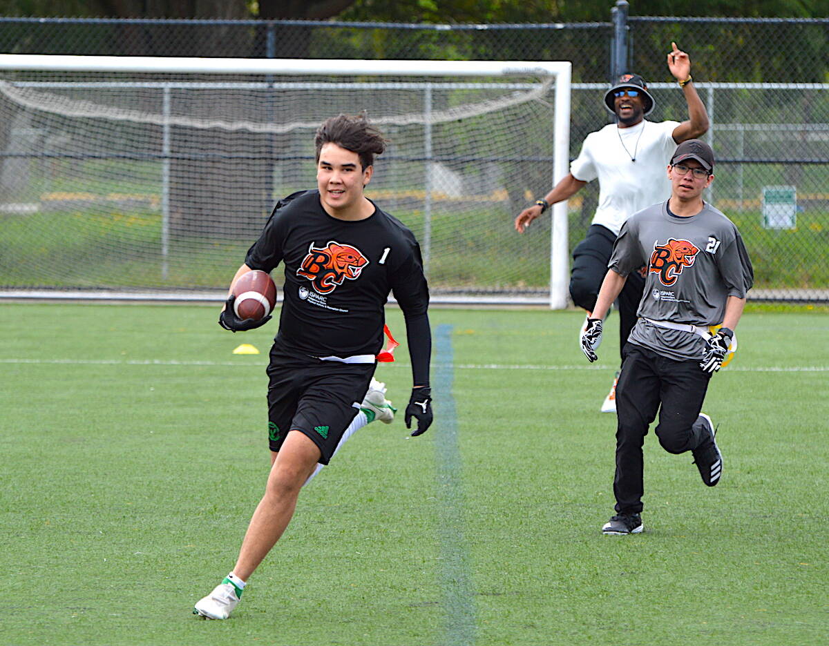 A Chilliwack Hornets player carries the ball for a touchdown against Surrey Dawgs during the BC Lions Indigenous Youth flag football tournament at Tom Binnie Park in Surrey on Sunday, April 30, 2023. (Photo: Tom Zillich)
