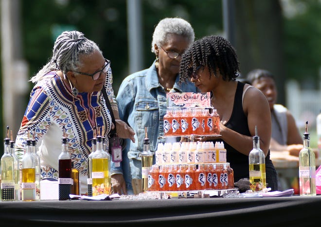 A'Sarah Green, right, of Sister Special Oil Bar, was one of the black-owned business owners to take part in the 2022 Juneteenth celebration in Alliance. This year's celebration will be Saturday, June 17, 2023, when a parade and fun activities are planned at Maple Beach Park.