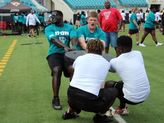 Linemen compete in a tug-of-war during the Lineman Challenge at the Jaguars Prep 11-On football tournament.