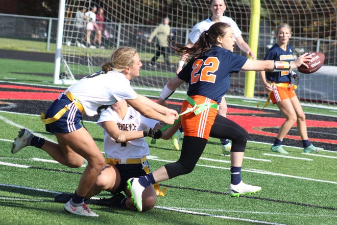 Summit's Dee Dee May runs the ball and tries to get to the end zone against Independence during the Williamson County Girls Flag Football tournament semifinals. Independence's Georgia Deeds (left) and Grace Martin (middle) defend on the play.