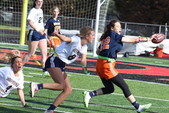 Summit's Dee Dee May runs the ball and tries to get to the end zone against Independence during the Williamson County Girls Flag Football tournament semifinals. Independence's Georgia Deeds (8) and Grace Martin (4) defend on the play.