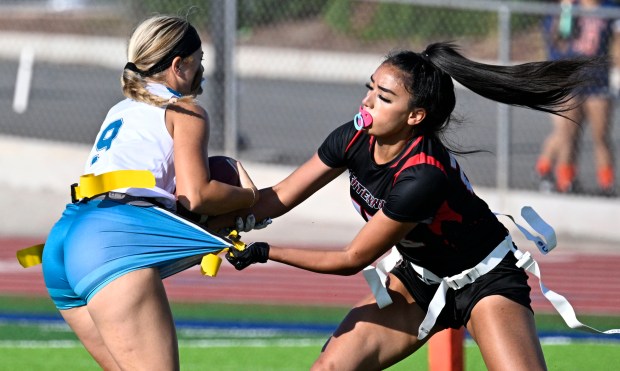 Santiago’s Hailey Cortez #9 is stopped by Centennial’s Herenui Silvey...