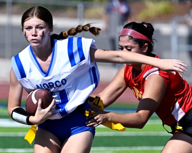 Norco’s Camryn Wagner #4 is stopped by Corona’s Kylie Martinez...