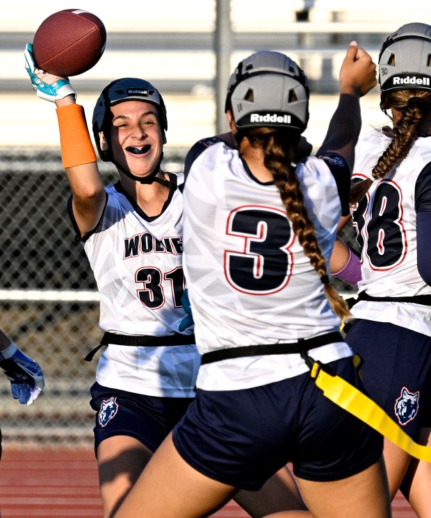 King’s Madison Rodriguez #31, left celebrates her touchdown catch with...