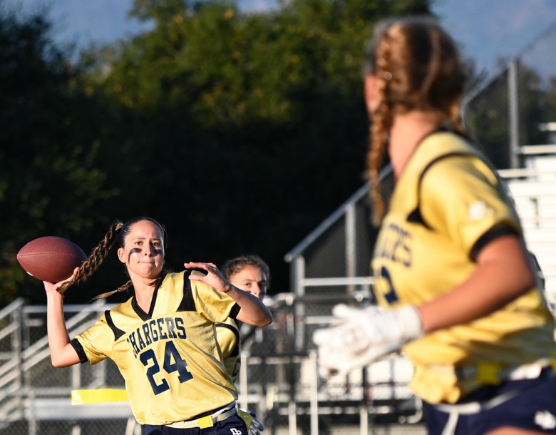 Gianna Nichols, senior quarterback of the Dos Pueblos High School flag football team, rears back to throw a pass to classmate Maddy Jones during the first game in program history held at Scott O’Leary Stadium on Aug. 24. The Chargers beat Bishop Diego 26-0. (Lily Chubb / Noozhawk photo)