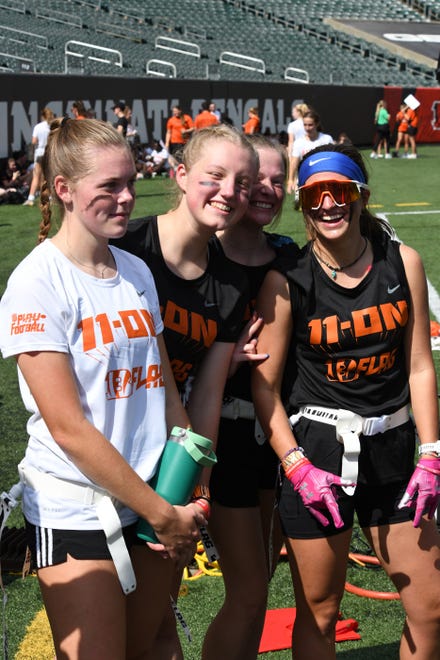 From left, Notre Dame Academy's Isabelle Fettig, Maddie Janszen, Sophia Graham and Annie Dierker are ready to play football at the girls flag football kickoff jamboree sponsored by USA Flag Football and the Cincinnati Bengals at Paycor Stadium, Sept. 30, 2023.