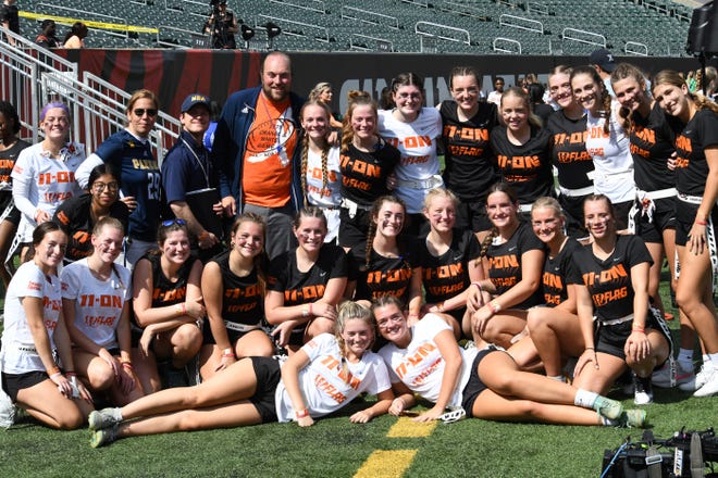 Ladies from the Notre Dame Academy flag football team pose for a photo at the girls flag football kickoff jamboree sponsored by USA Flag Football and the Cincinnati Bengals at Paycor Stadium, Sept. 30, 2023.