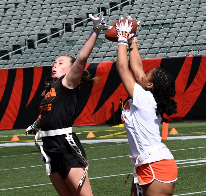 This player defends another as she makes a reception at the girls flag football kickoff jamboree sponsored by USA Flag Football and the Cincinnati Bengals at Paycor Stadium, Sept. 30, 2023.
