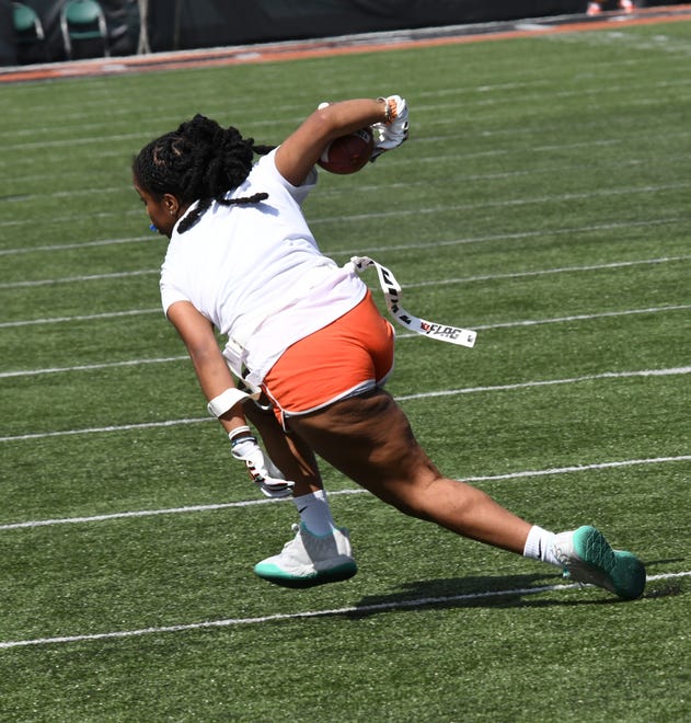 This player cuts the corner and picks up a first down for OO at the girls flag football kickoff jamboree sponsored by USA Flag Football and the Cincinnati Bengals at Paycor Stadium, Sept. 30, 2023.