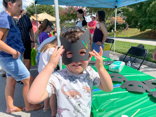 Callan Smith, 3, seems thrilled with the mask that magically turns colors at the annual Art Fest at the Farragut Community Center on Sept. 10, 2023.