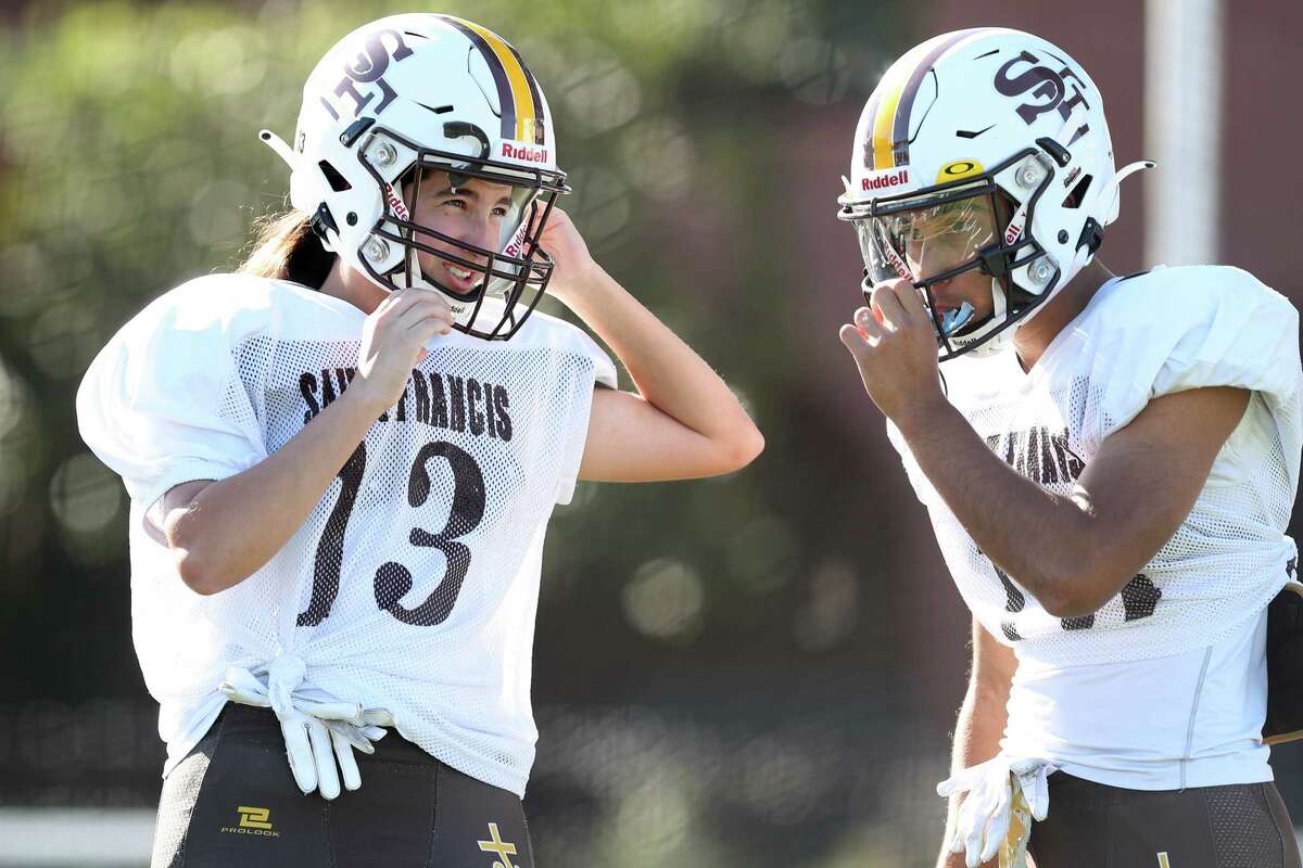 St. Francis High School football players Kate Longo (13) and Joseph Paul Payer practice in Mountain View.