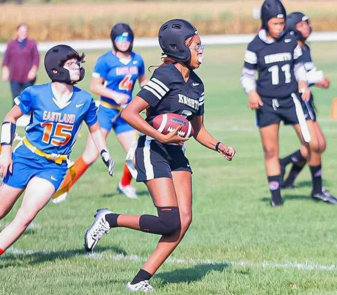 Auburn ballcarrier Carrington Weatherly tries to slip past Eastland/Pearl City defenders during a game this past fall in the Rockford Park District, and the Chicago Bears, Northern Illinois Girls High School Flag Football League based out of Rockford.