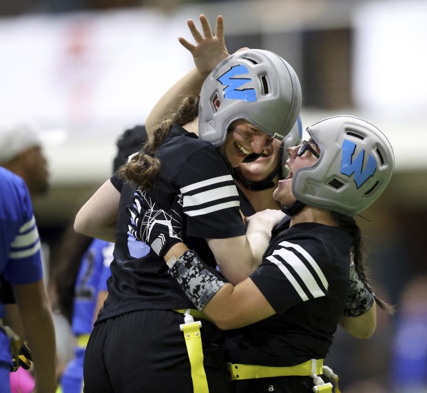 Willowbrook High School's Delaney Coulter, left, celebrates with teammates after...