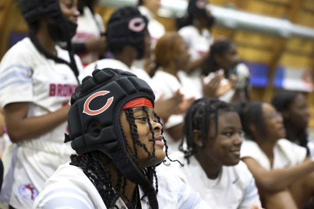 Kenwood Academy rusher Kia Shorts relaxes with her team before...