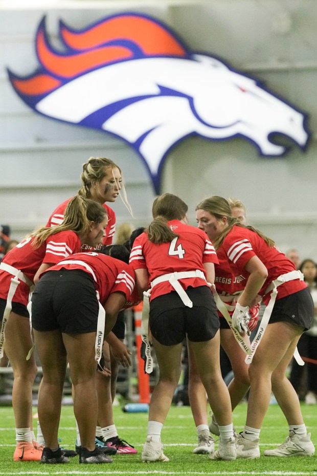 Regis Jesuit High School's players gather on the field during the game against Valor Christian High School at Centura Health Training Center on Saturday, Oct. 14, 2023 in Englewood, Colorado. (Rebecca Slezak/ Special to The Denver Post)