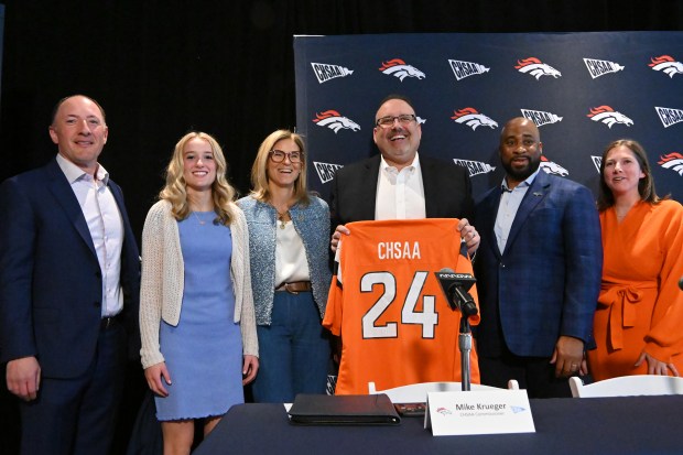 From left, Bobby Mestas, director of youth and high school football development, Saylor Swanson of Arvada West, Denver Broncos owner Carrie Walton Penner, CHSAA commissioner Mike Krueger, Damani Leech, Broncos team president, and Allie Engelken, Vice President of Community Development, celebrate historic vote to make girls flag football a sanctioned sport in Colorado at the Pat Bowlen Fieldhouse of Centura Health Training Center in Englewood on Wednesday, April 24, 2024. (Photo by Hyoung Chang/The Denver Post)