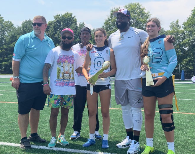 Former Philadelphia Eagle and Neptune standout Vinny Curry (second from right) poses with the game MVPs.
