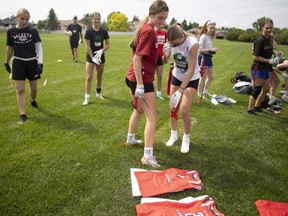 Players from the Saskatchewan-based girls 15U flag football team see their new jerseys at Ecole Wilfrid Walker School on Wednesday, July 3, 2024 in Regina.